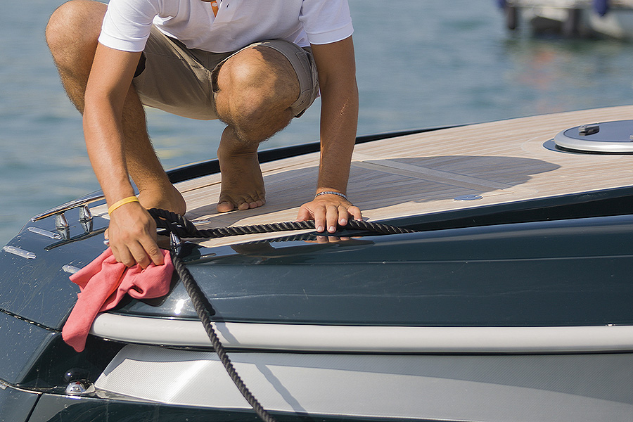 man polishing yacht exterior